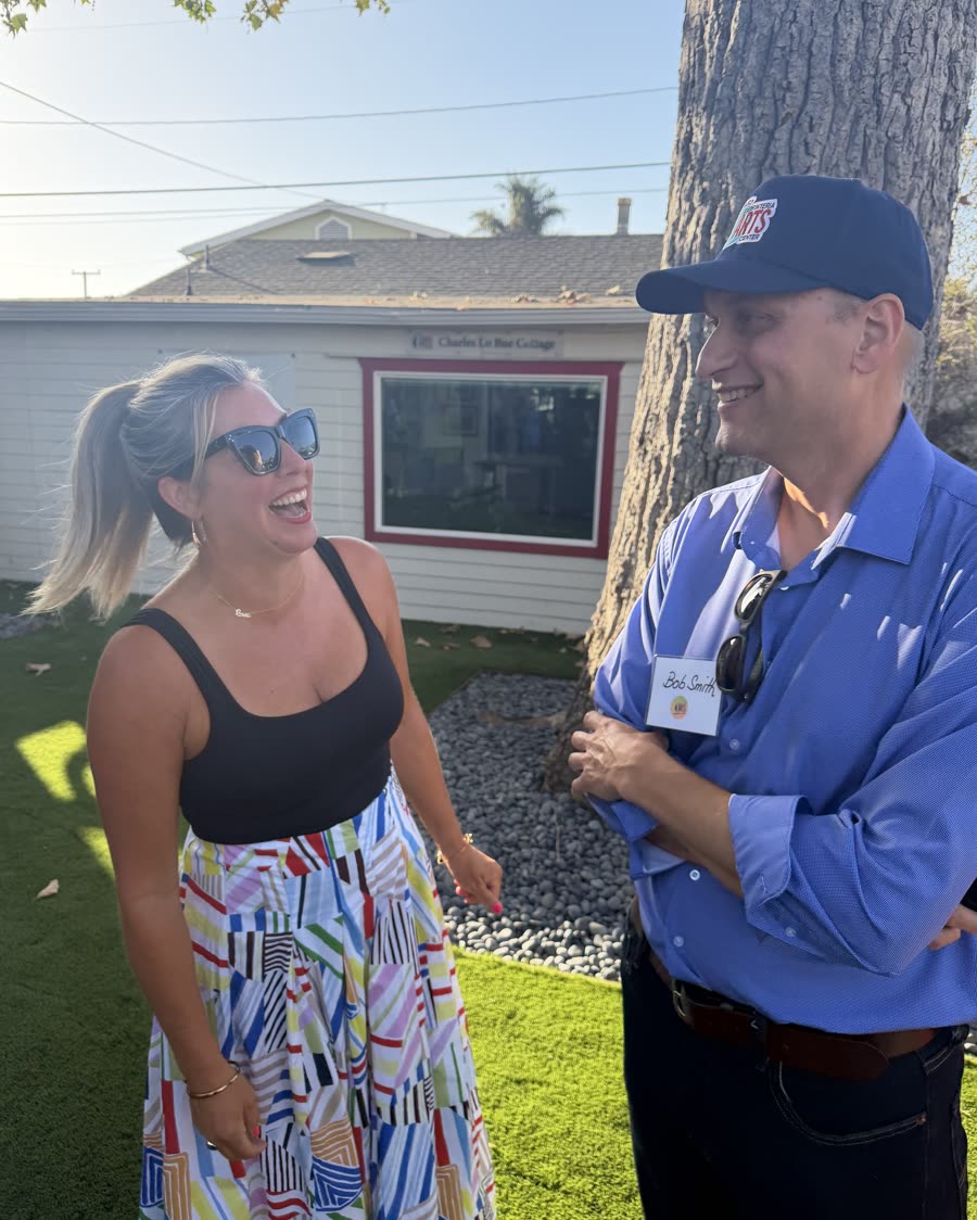 Bob Smith in conversation with a resident in her front yard
