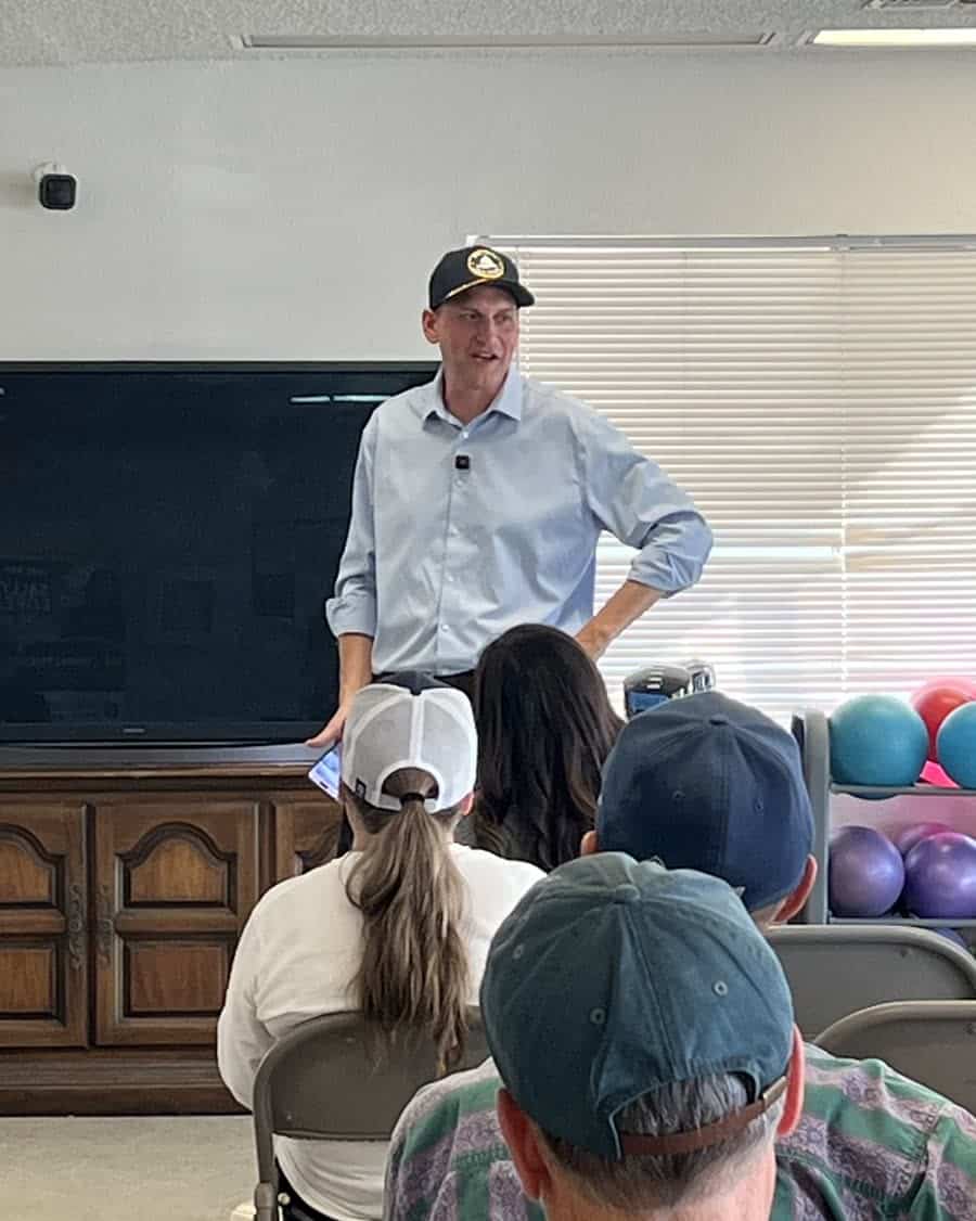 Bob Smith speaking to a seated audience at a town hall