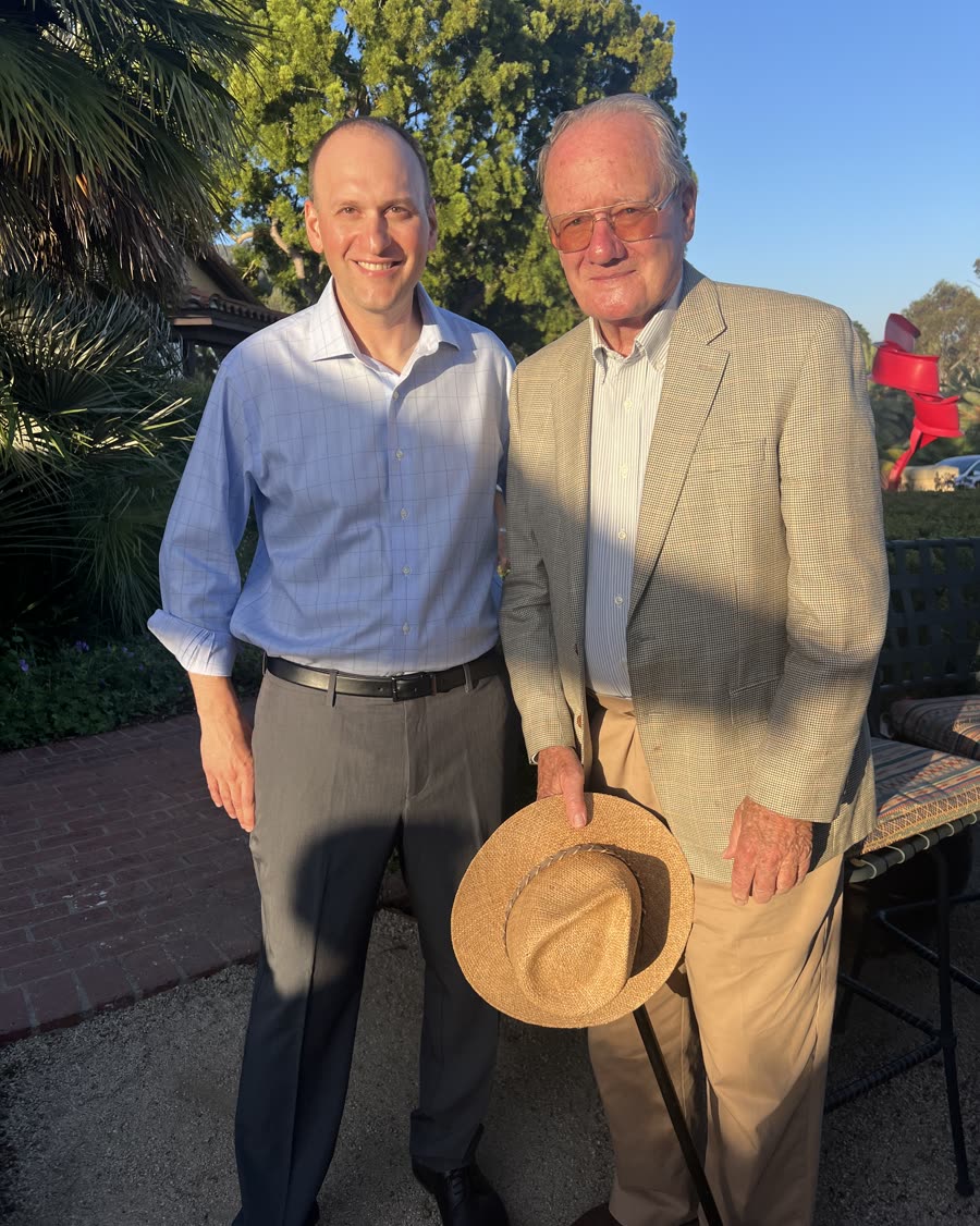 Bob Smith standing with an older supporter outdoors